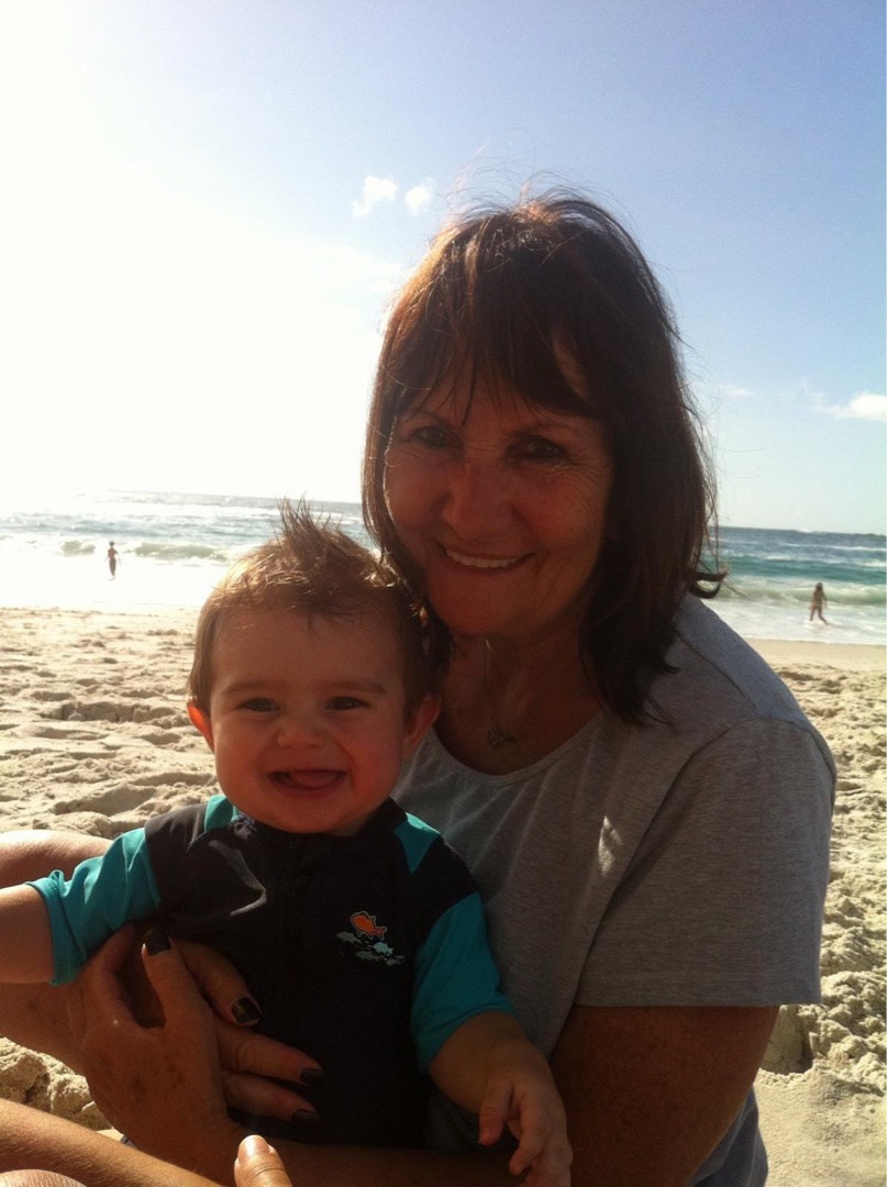 Baby with grandmother at beach