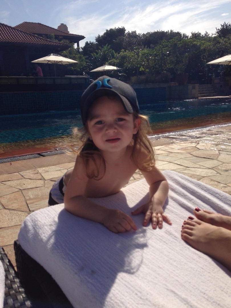 Taye poolside with cap