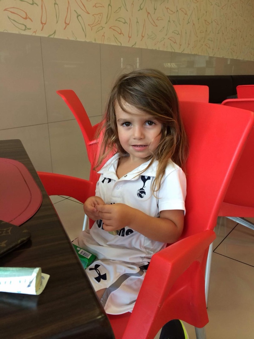 Taye in Spurs kit on red chair