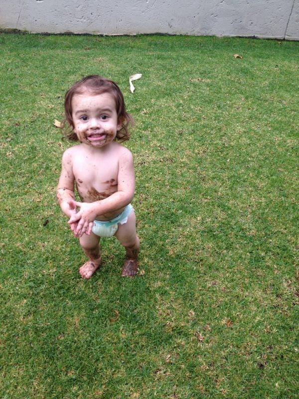 Muddy toddler in garden